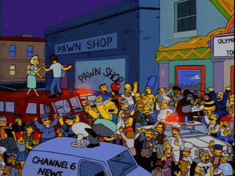 a pawn shop is surrounded by a large crowd of people
