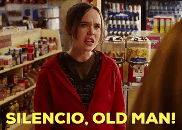 a woman in a red hoodie says silencio old man in a store
