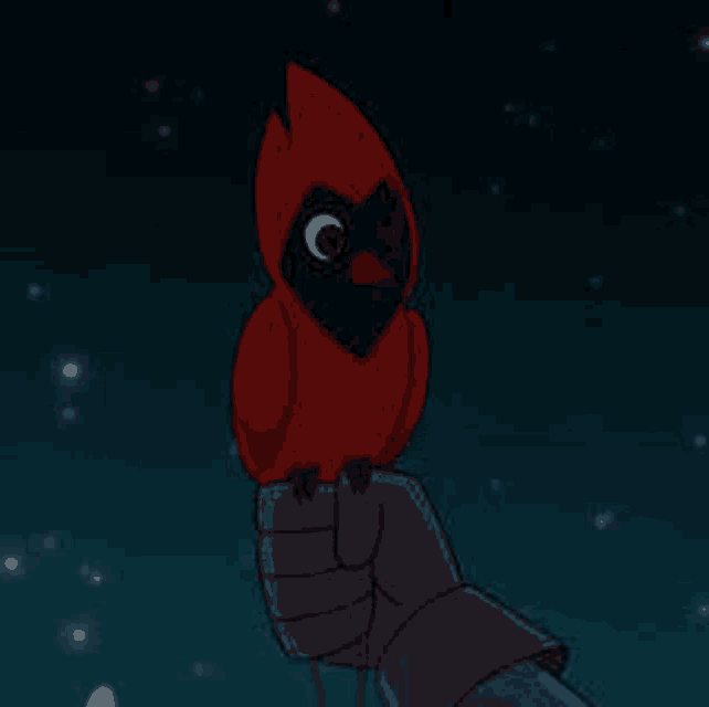 a person is holding a small red bird with a black head on their hand .