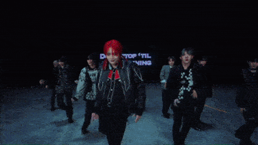 a person with green hair is standing in front of a sign that says " don t stop til you 're shining "