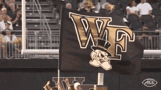 a black and gold flag with the letters w and t on it