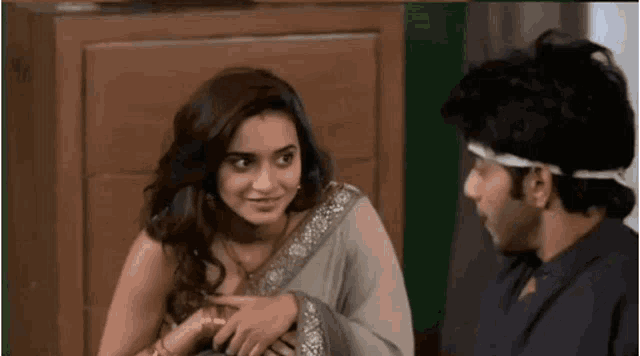 a man and a woman are sitting next to each other and talking