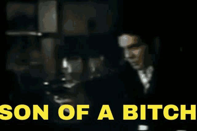 a blurry picture of a man with the words son of a bitch in yellow letters