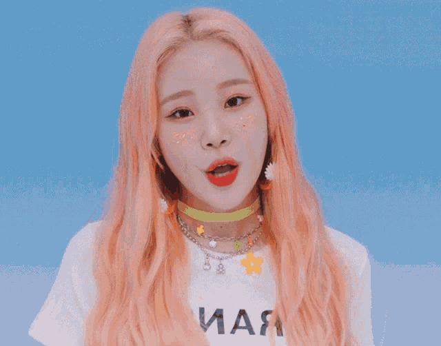 a girl with pink hair is wearing a white t-shirt that says " иая "