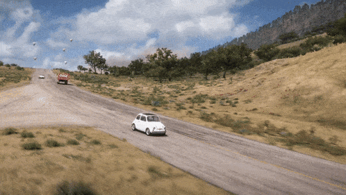 a white car is driving down a road with a coca cola truck in the background