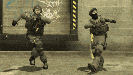 two soldiers are dancing in front of a wall that has the word ' safety ' on it