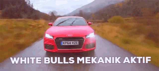 a red car is driving down a road with the words white bulls mekanik aktif below it