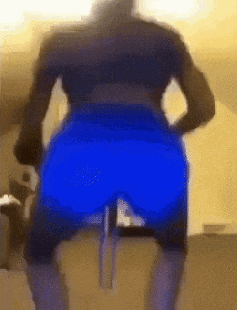 a blurry picture of a man in blue shorts