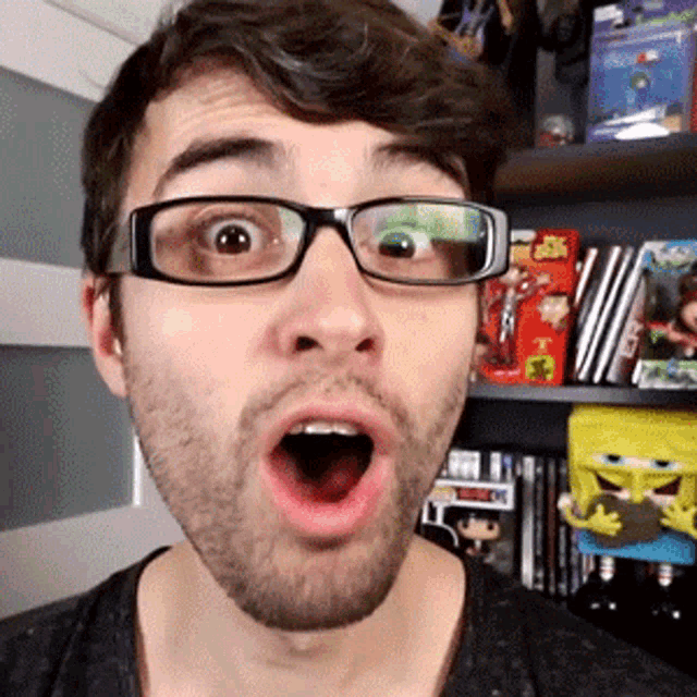 a man wearing glasses is making a funny face