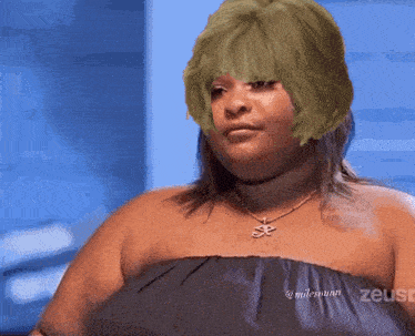 a woman with green hair is wearing a necklace that says zeuse