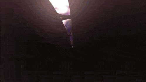 a light is shining through a hole in a wall