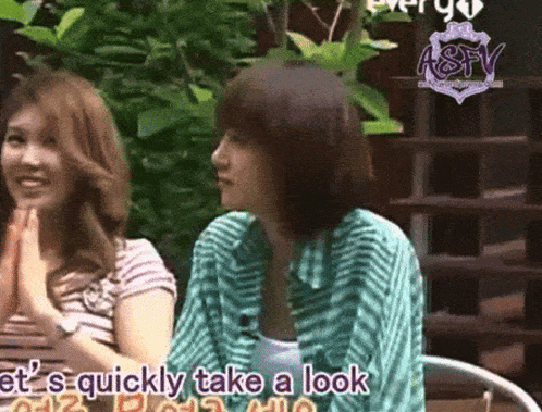 two women are sitting next to each other and one of them is saying " let 's quickly take a look "