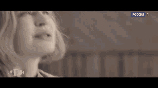 a close up of a woman 's face in a sepia tone .