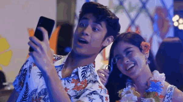a man and woman are taking a selfie together