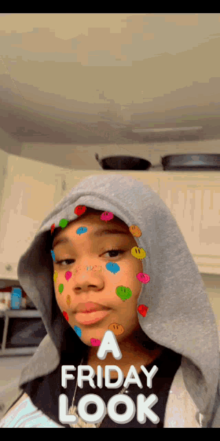 a girl is wearing a hoodie with smiley faces on her face and the words a friday look above her