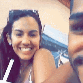 a man and a woman are taking a selfie together and smiling .