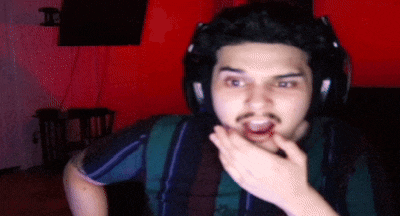 a man wearing headphones and a striped shirt is making a surprised face