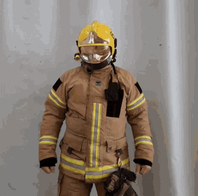 a fireman wearing a helmet and goggles with the letter g on it
