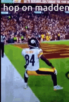 a football player kneeling on the field with the number 84 on his jersey .