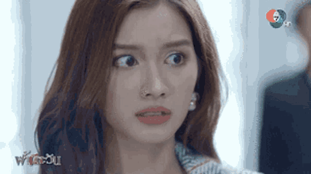 a close up of a woman making a funny face in front of a tv screen that says 7 hd