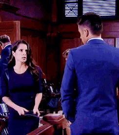 a man and a woman are standing next to each other in a room .