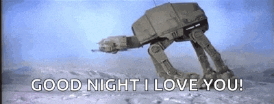 a robot is walking in the snow with the words `` good night i love you '' written on it .