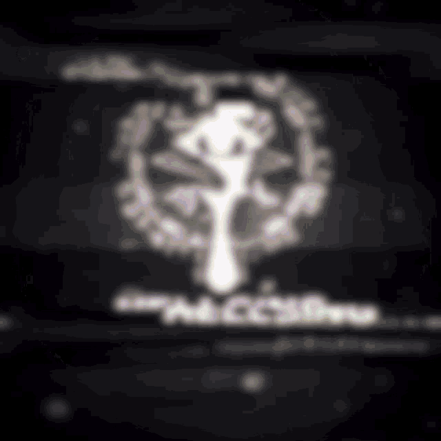 a blurred image of a tree in a circle with the word addictive on the bottom .