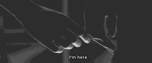 a black and white photo of a person holding another person 's hand with the words `` i 'm here '' .