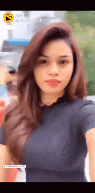a woman taking a selfie with the number 006 on the bottom right