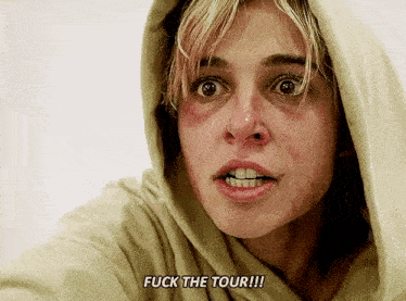 a woman in a hooded sweatshirt is screaming and says `` fuck the tour '' .