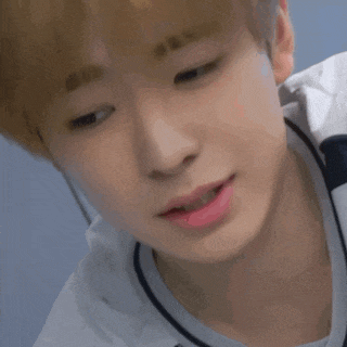 a close up of a young man 's face with a white shirt and pink lipstick .