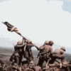 a group of soldiers holding an american flag on top of a hill .