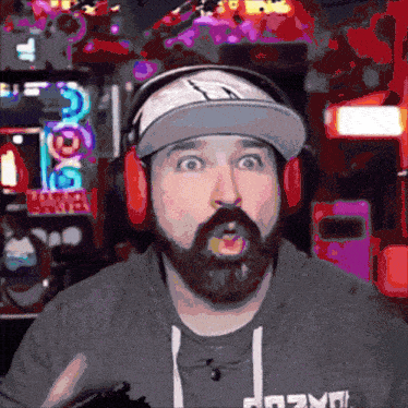 a man with a surprised look on his face is wearing headphones and a sweatshirt that says aozyn
