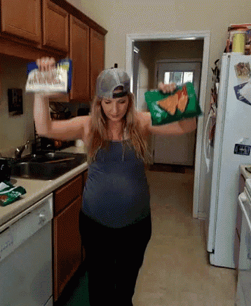 a woman is holding a bag of chips over her head