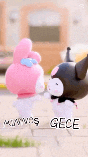 a couple of hello kitty dolls standing next to each other on a sidewalk .