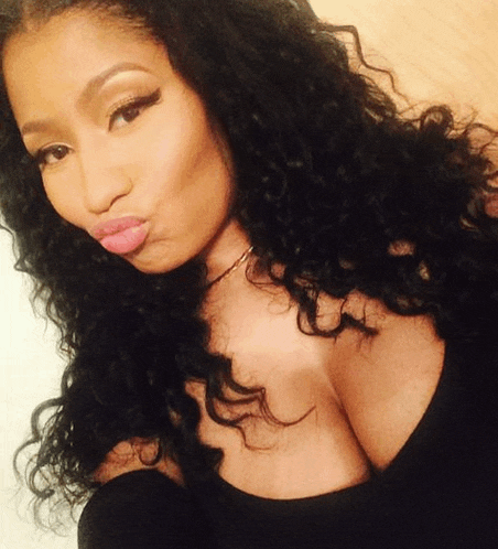 a woman with curly hair is wearing a black top and making a face