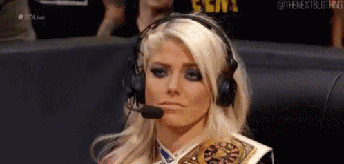 a woman wearing headphones and a microphone is holding a wrestling championship .