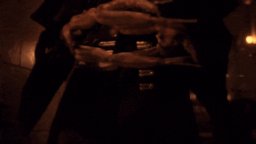a hooded figure with glowing eyes and a cross on his chest