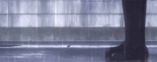 a person is standing in the rain with an umbrella and a bird is flying in the background .