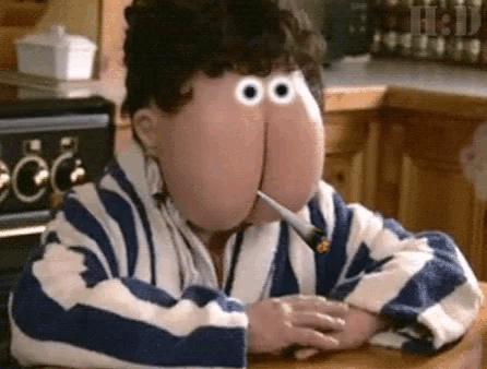a cartoon character with big eyes is smoking a cigarette .