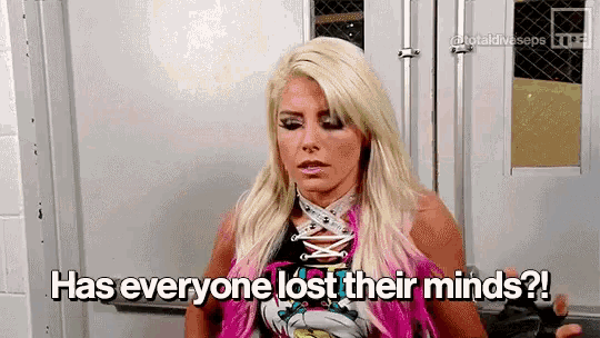 a female wrestler is standing in a room with the words `` has everyone lost their minds '' written on her face .