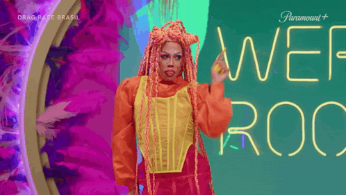 a drag queen with red hair is standing in front of a sign that says wet roc .