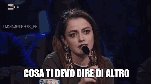 a woman speaking into a microphone with the words cosa ti devo dire di altro written below her
