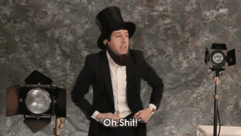 a man in a top hat and suit says oh shit