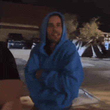 a blurry picture of a person wearing a blue jacket