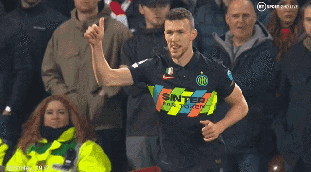 a soccer player wearing a shirt that says " sinter " is giving a thumbs up