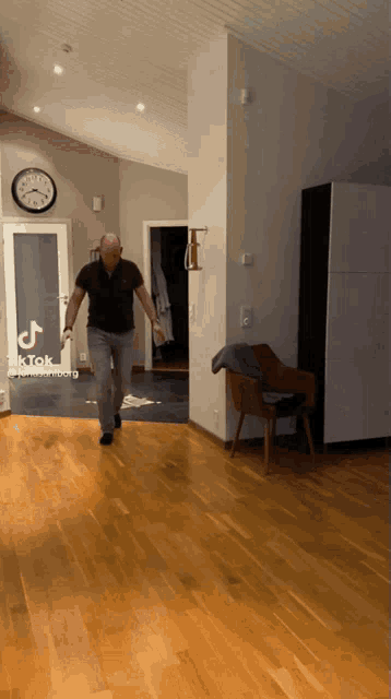 a man is running in a living room with a tiktok watermark