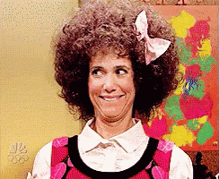 a woman with an afro and a bow in her hair makes a funny face