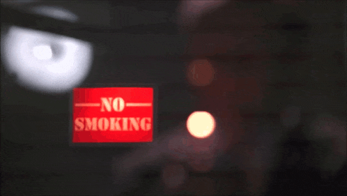 a man is lighting a cigarette through a window