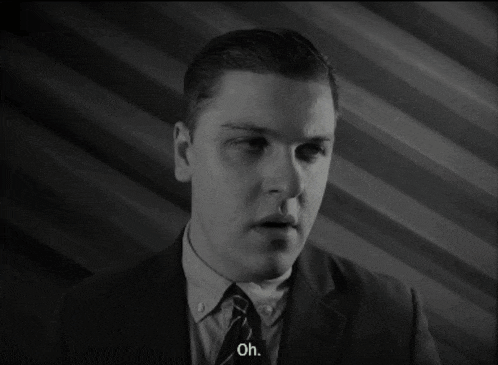 a man in a suit and tie is saying oh in a black and white photo